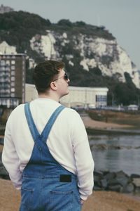 Rear view of man looking at waterfall