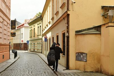 Rear view of woman walking on street in city