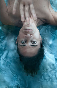 Directly above shot of shirtless women lying on floor