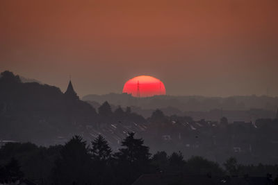 Silhouette trees against sky during sunset