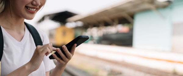 Midsection of woman using mobile phone