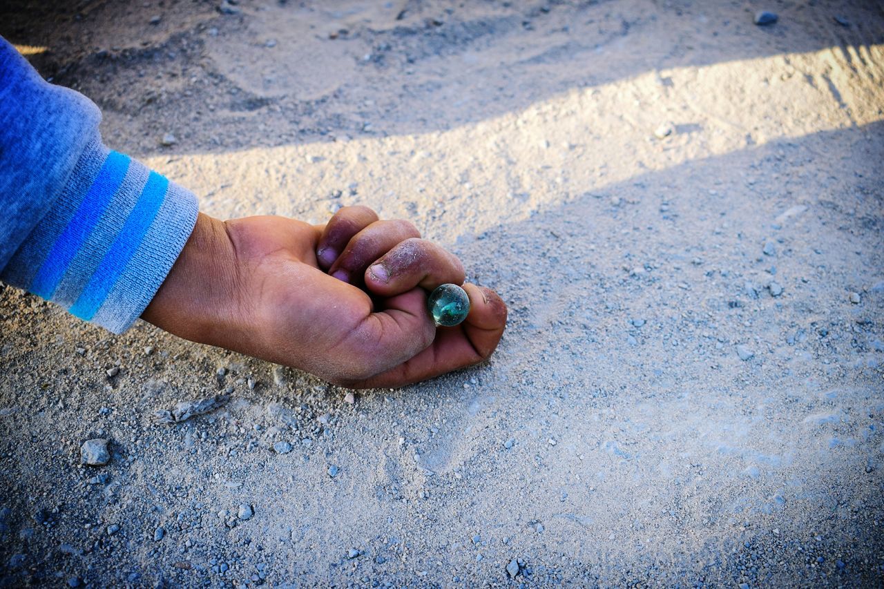 real people, outdoors, one person, day, human body part, human hand, low section, sand, beach, human leg, close-up