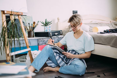 Female artist creates a sketch. home studio of a creative person.