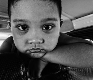 Close-up portrait of boy sitting at home