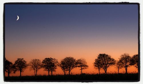 Scenic view of landscape against sky at sunset