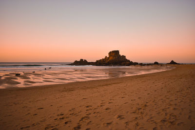 Scenic view of sea against clear sky during sunset