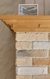 Element of a stone fireplace in a house made of old bricks with markings