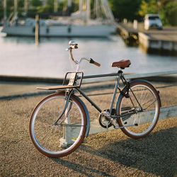 Close-up of bicycle by water