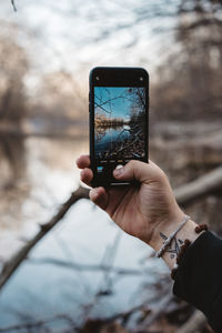 Midsection of man using mobile phone