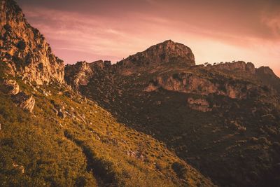 Scenic view of rocky mountains against sky during sunset