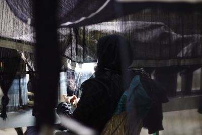 Rear view of woman sitting in bus