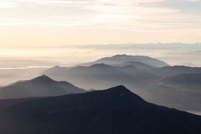 Scenic view of mountains against sky during sunset