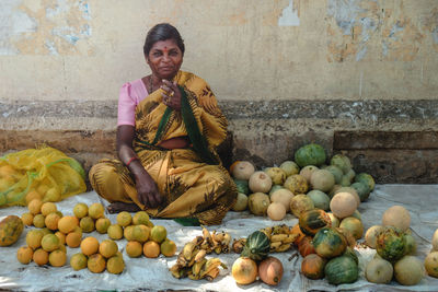 Young woman sitting at market stall