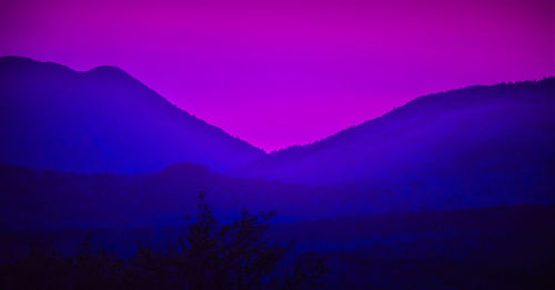 Scenic view of silhouette mountain against romantic sky