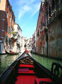 Canal amidst buildings against sky