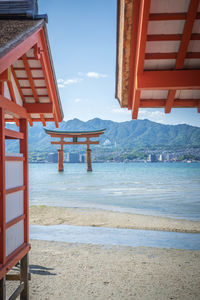 Lifeguard hut on beach against sky