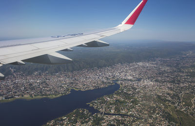 Aerial view of airplane wing over landscape