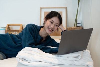 Young woman using laptop at home