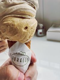 Close-up of hand holding ice cream