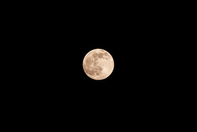 Low angle view of full moon against sky at night