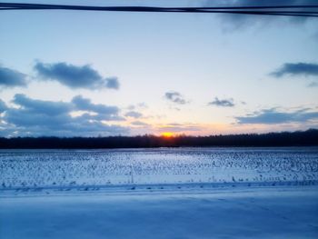 Scenic view of lake against sky during winter