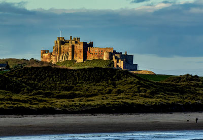 Majestic bamburgh castle looms over the northumberland coast