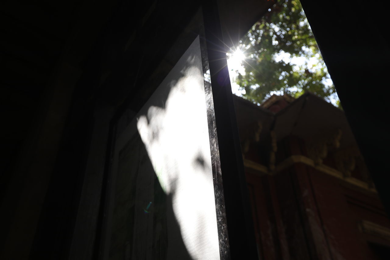 LOW ANGLE VIEW OF SUNLIGHT STREAMING THROUGH WINDOW IN BUILDING