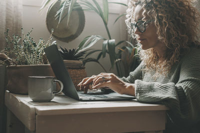 Young woman using laptop at home