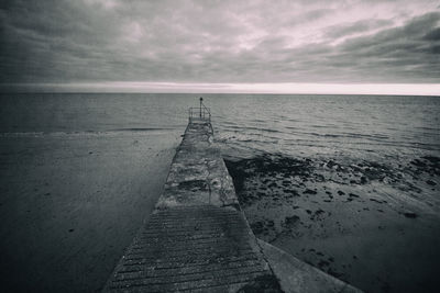 Pier over sea against sky