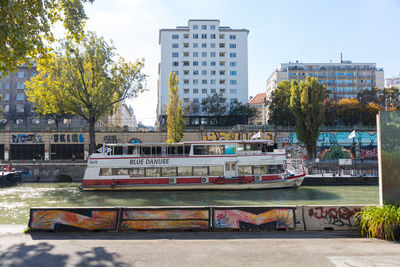 View of buildings against trees in city