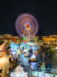 Illuminated ferris wheel at night