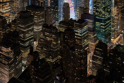 Aerial view of illuminated buildings in city at night