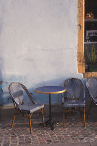 Empty chairs and tables in yard