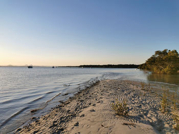 Scenic view of sea against clear sky during sunset