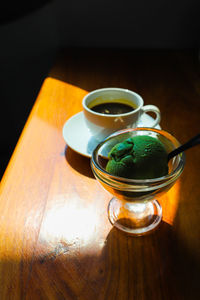 Close-up of green tea ice cream cup on table