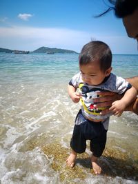 Full length of a boy holding beach