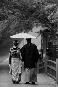 Rear view of people walking on street