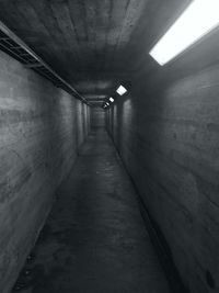 Empty corridor in illuminated tunnel