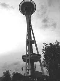Low angle view of eiffel tower against cloudy sky