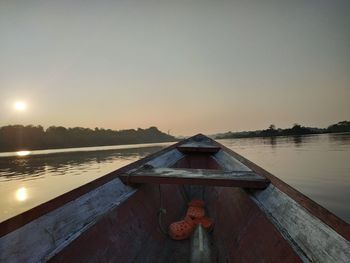 Scenic view of lake against clear sky during sunset