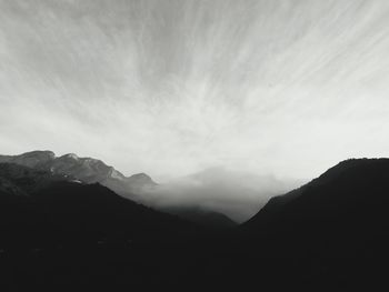 Scenic view of silhouette mountains against sky