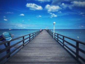 Pier over sea against sky