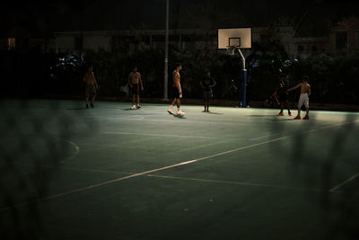 People playing basketball court