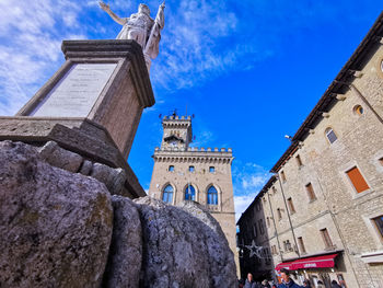 Low angle view of old building against blue sky