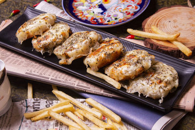 Cheese garlic bread with on plate over wooden background with copy space.