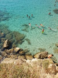 High angle view of people swimming in sea