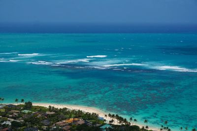 Scenic view of hawaiian ocean against blue sky on summer day