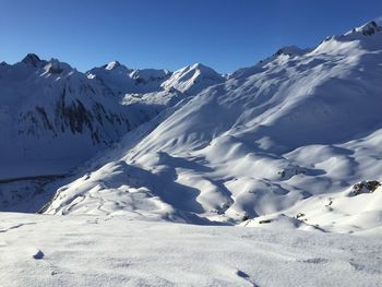 Scenic view of snow covered mountains against sky