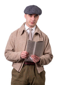 Portrait of young man standing against white background
