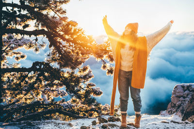 Rear view of woman standing on snow